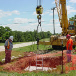 Setting a manhole for cable access